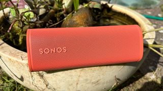 Sonos Roam 2 wireless speaker on plant pot showing Sonos logo