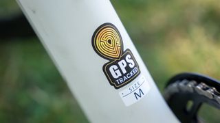 The frame of the Urtopia Carbon 1 Pro electric bike with the GPS Tracked label