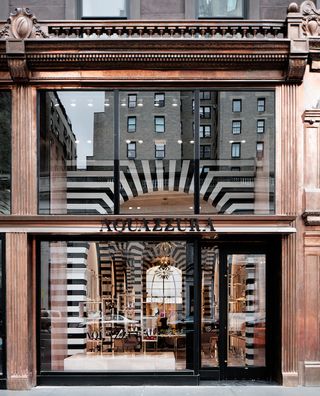 Situated between 74th and 75th Streets on Madison Avenue, the two-floor boutique features a 17-foot glass storefront that makes its black and white interior all the more arresting