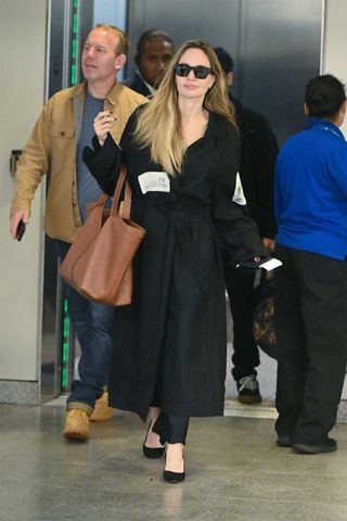 Angelina Jolie wears the Saint Laurent Y Bag in brown.