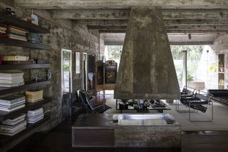 brutalist 1970s house by chu ming silveira showing raw concrete and lived in interiors and green garden