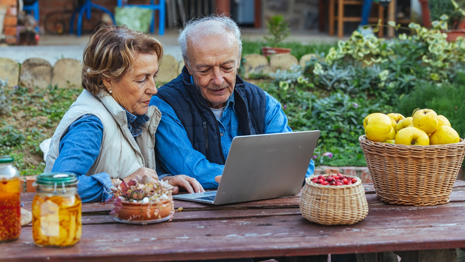 Senior couple using laptop computer to pick their next travel destination or to shop something online.