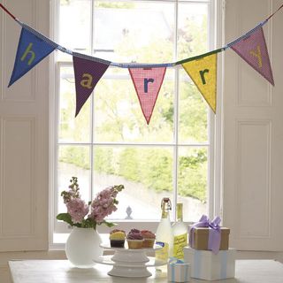 room with bunting flag on window and gifts