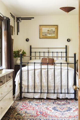 cast-iron bedstead in converted schoolhouse