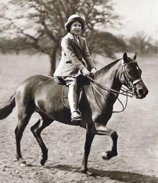 Queen Elizabeth on a horse as a child