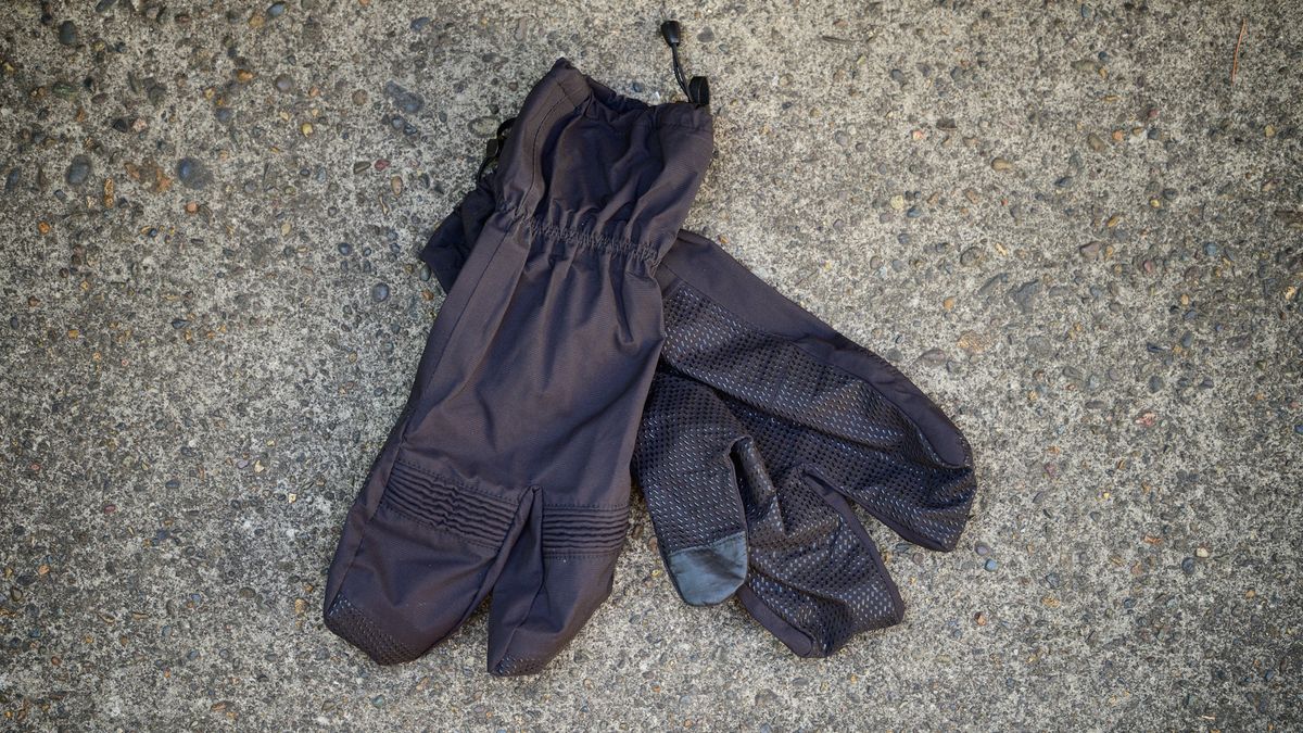 Black Sportful lobster gloves on some concrete