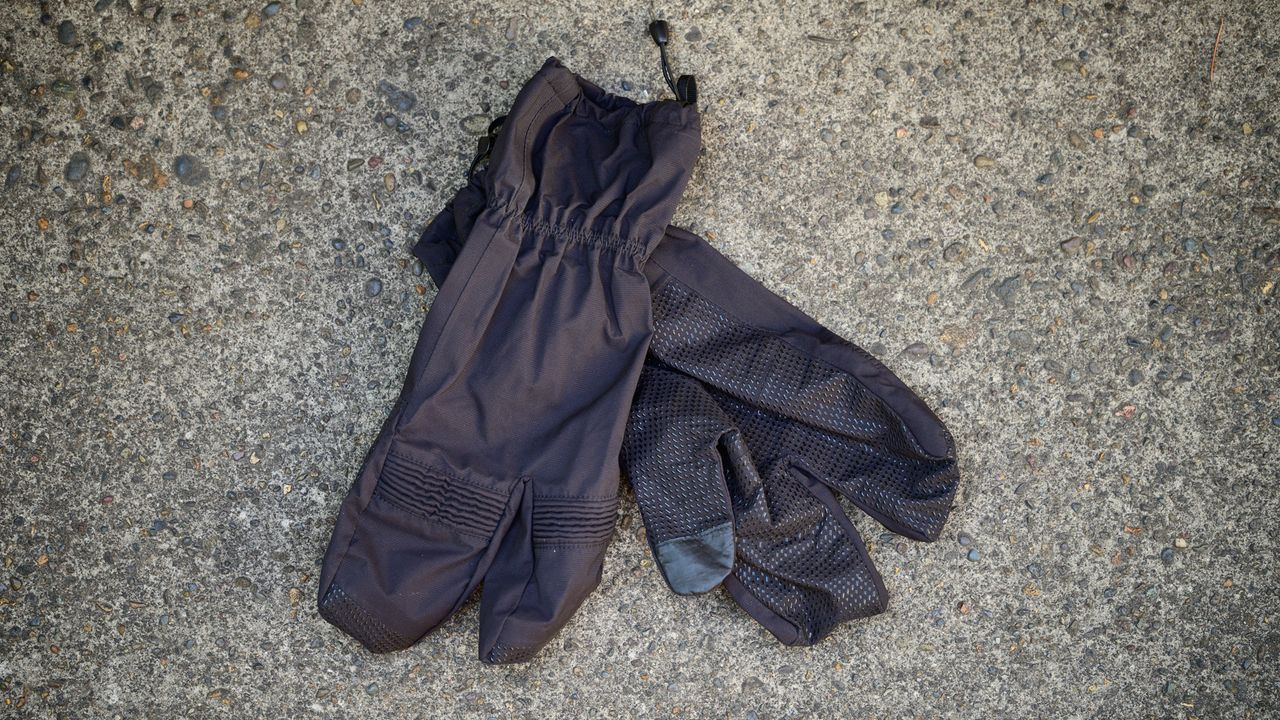 Black Sportful lobster gloves on some concrete