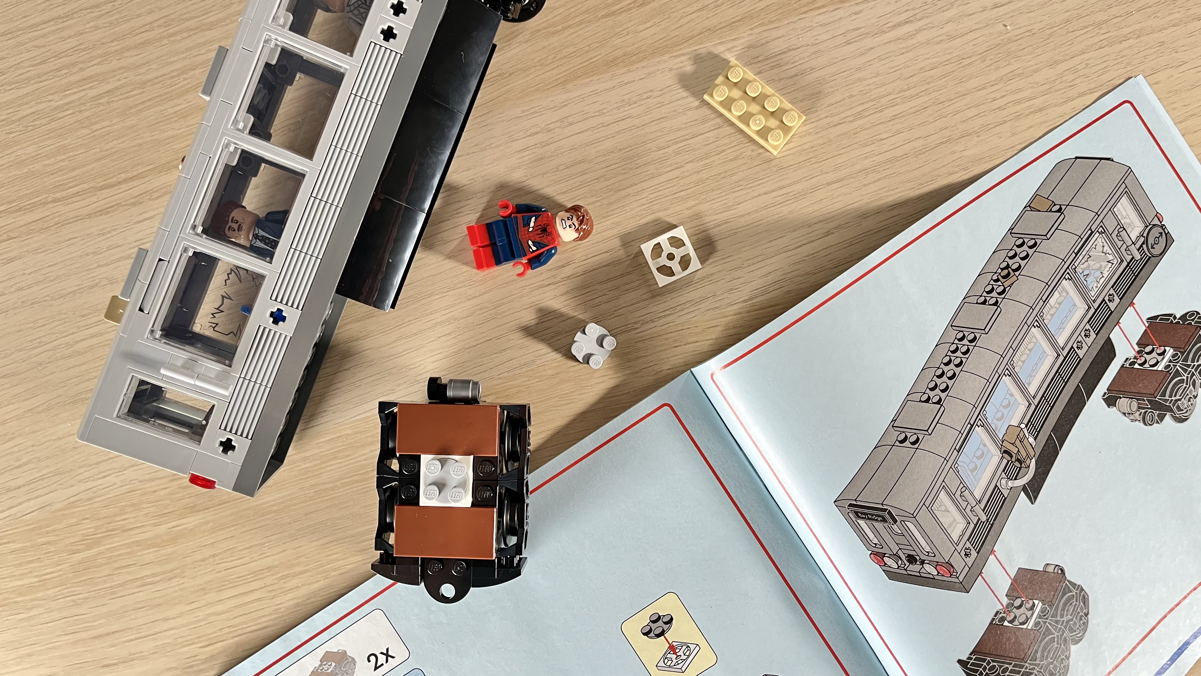 Top-down view of Spider-Man Lego set and instructions being built