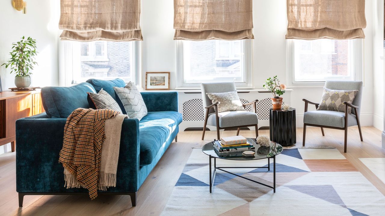 living room with blue sofa and armchairs