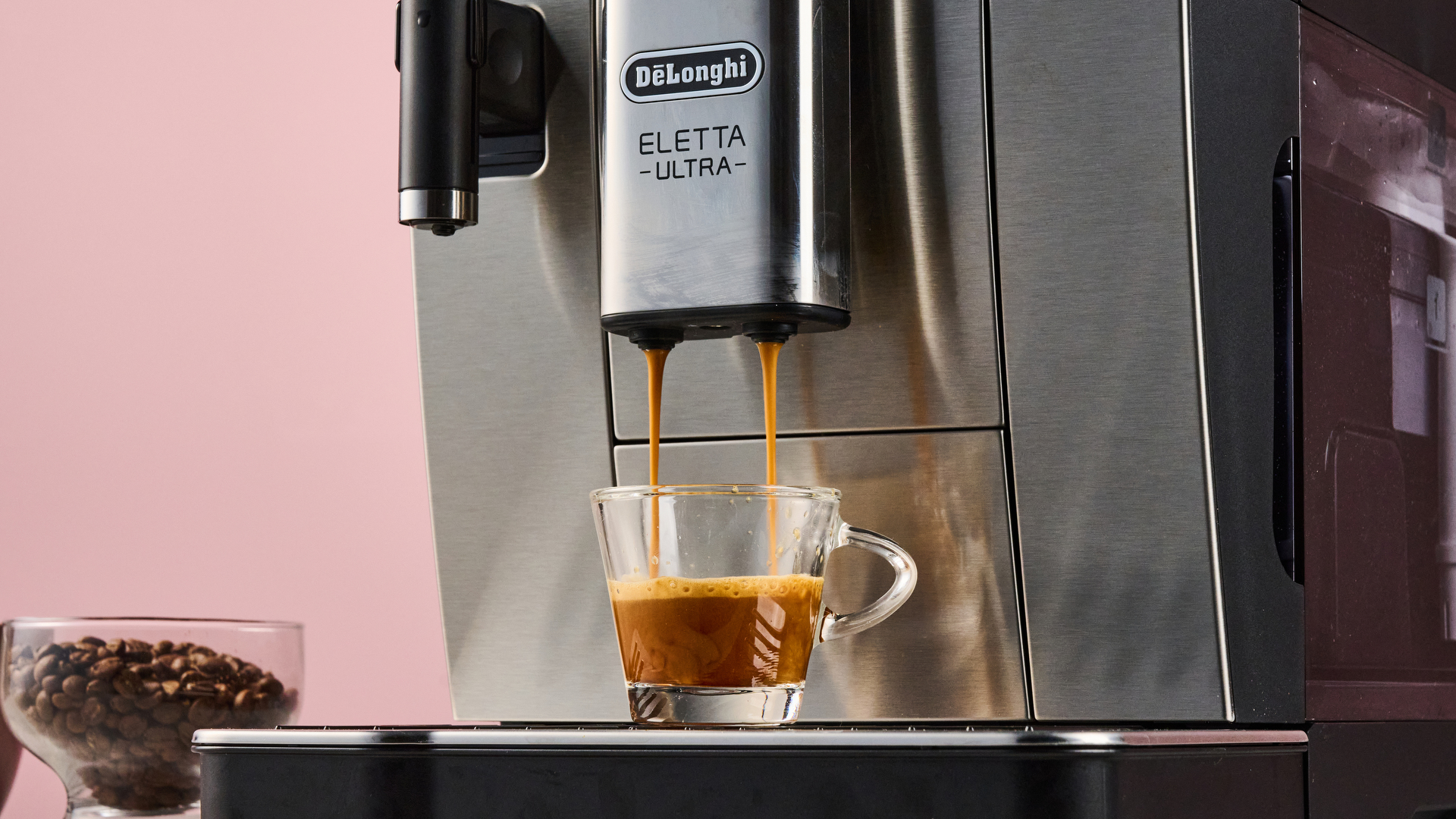 The De'Longhi Eletta Ultra extracting a double espresso into an espresso glass.