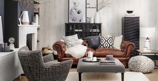 monochrome living room with brown leather sofa and geo patterned armchair and stool coffee table