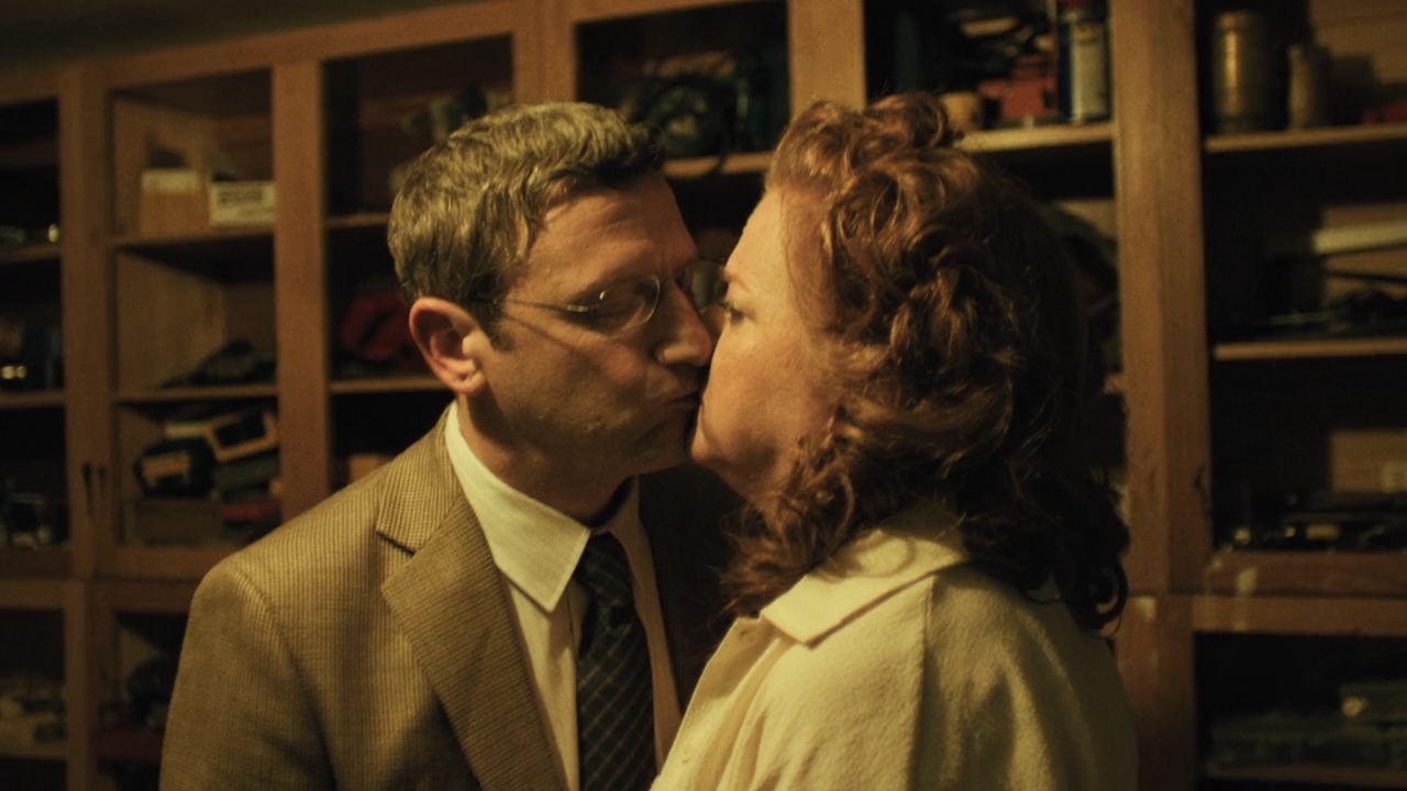 Ron awkwardly kissing strange man's wife in The Chair Company Episode 5