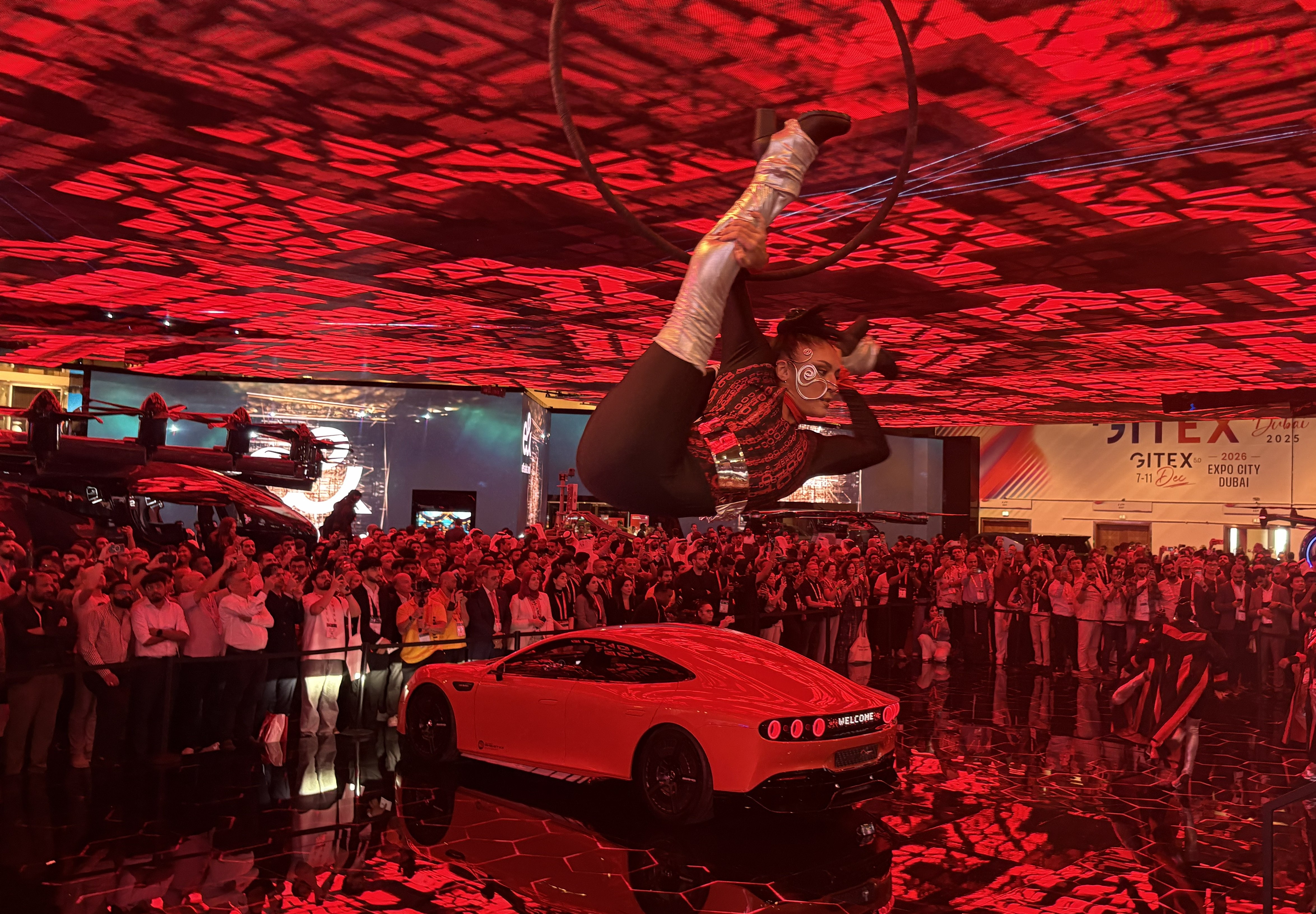 An image of a dancer above a car at GITEX