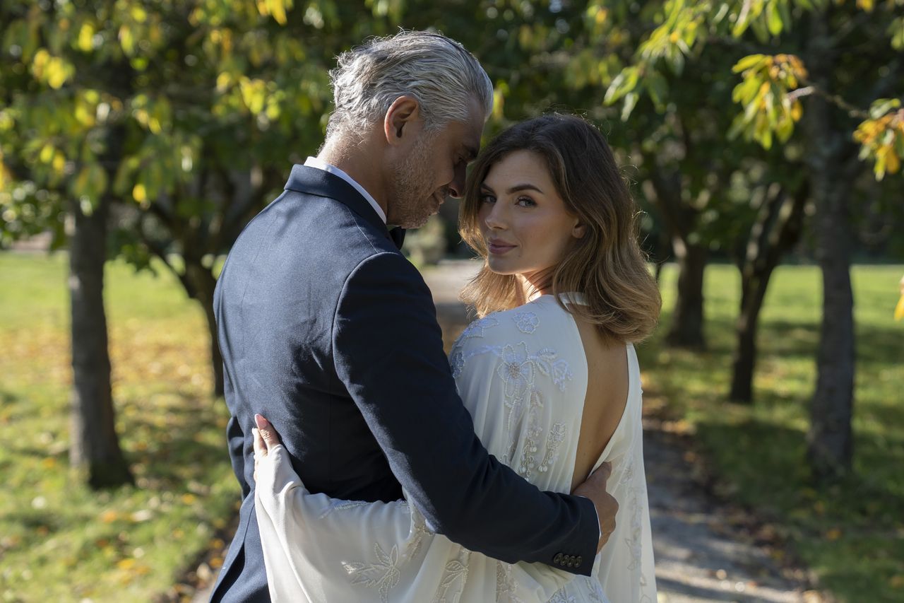 A bride and groom in a park