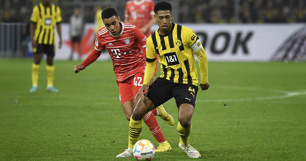 Jamal Musiala of Bayern Munich and Jude Bellingham of Borussia Dortmund battle for the ball during the Bundesliga match between Borussia Dortmund and FC Bayern München at Signal Iduna Park on October 8, 2022 in Dortmund, Germany.