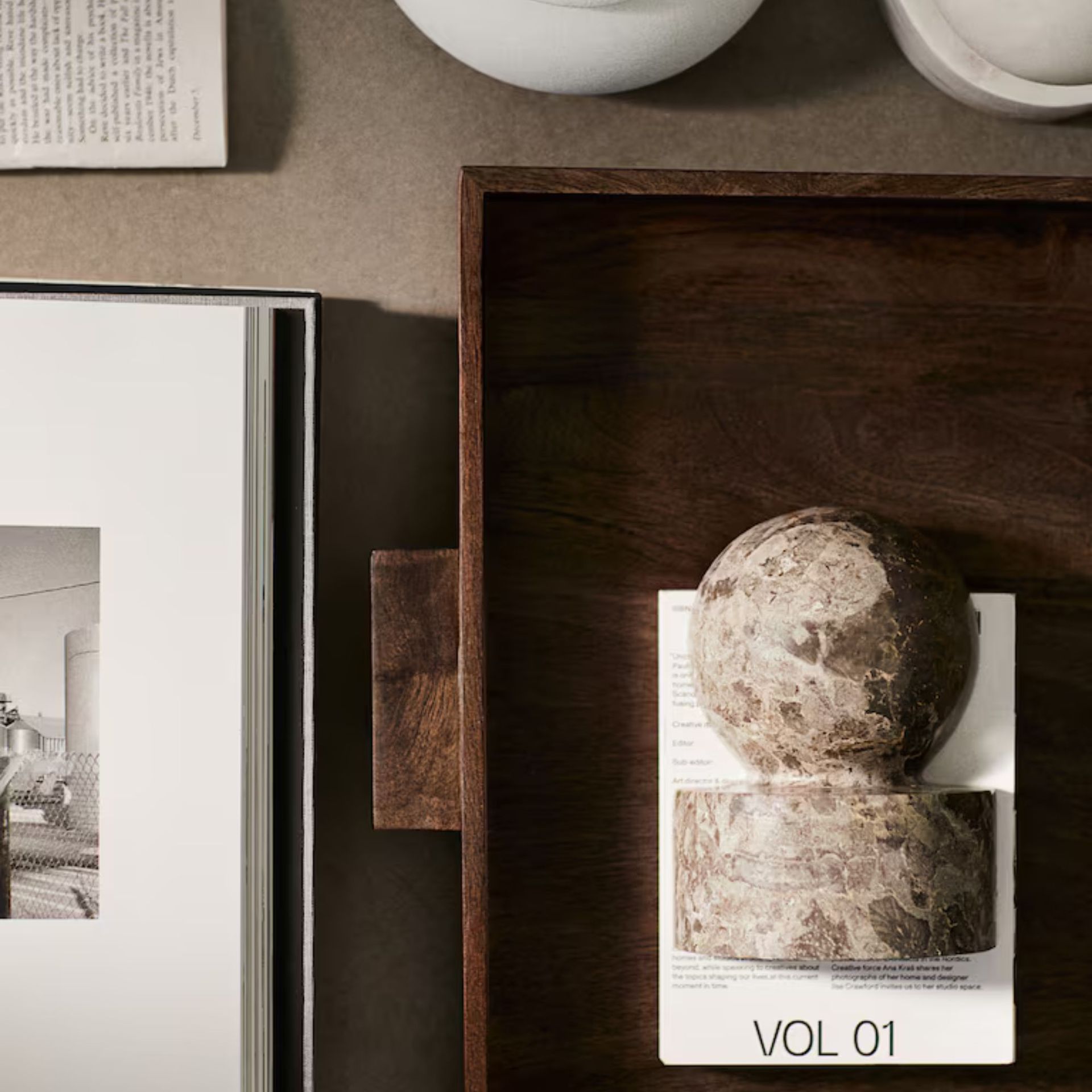Marble Bookend in a wooden tray on a beige table.