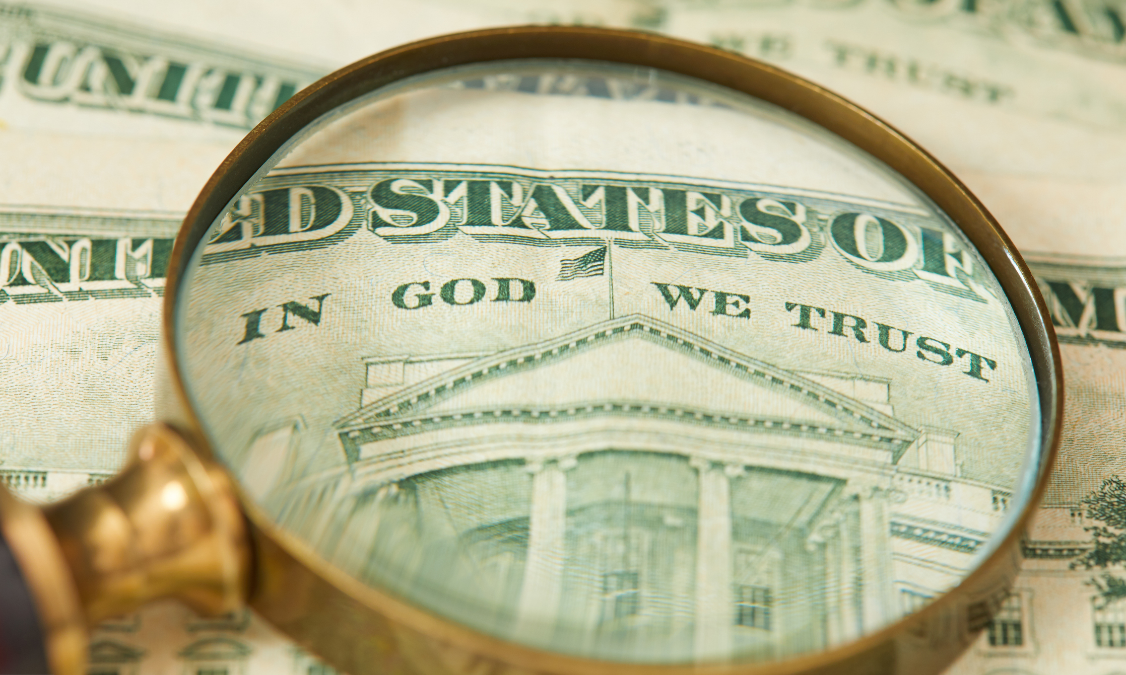 A magnifying glass on a bill.
