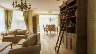 A cozy living room with luxury furniture in country house with a roller ladder