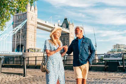 A couple walking in London on a sunny day