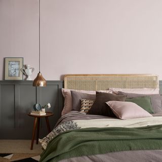 bedroom with blush pink wall hanging light and cushions