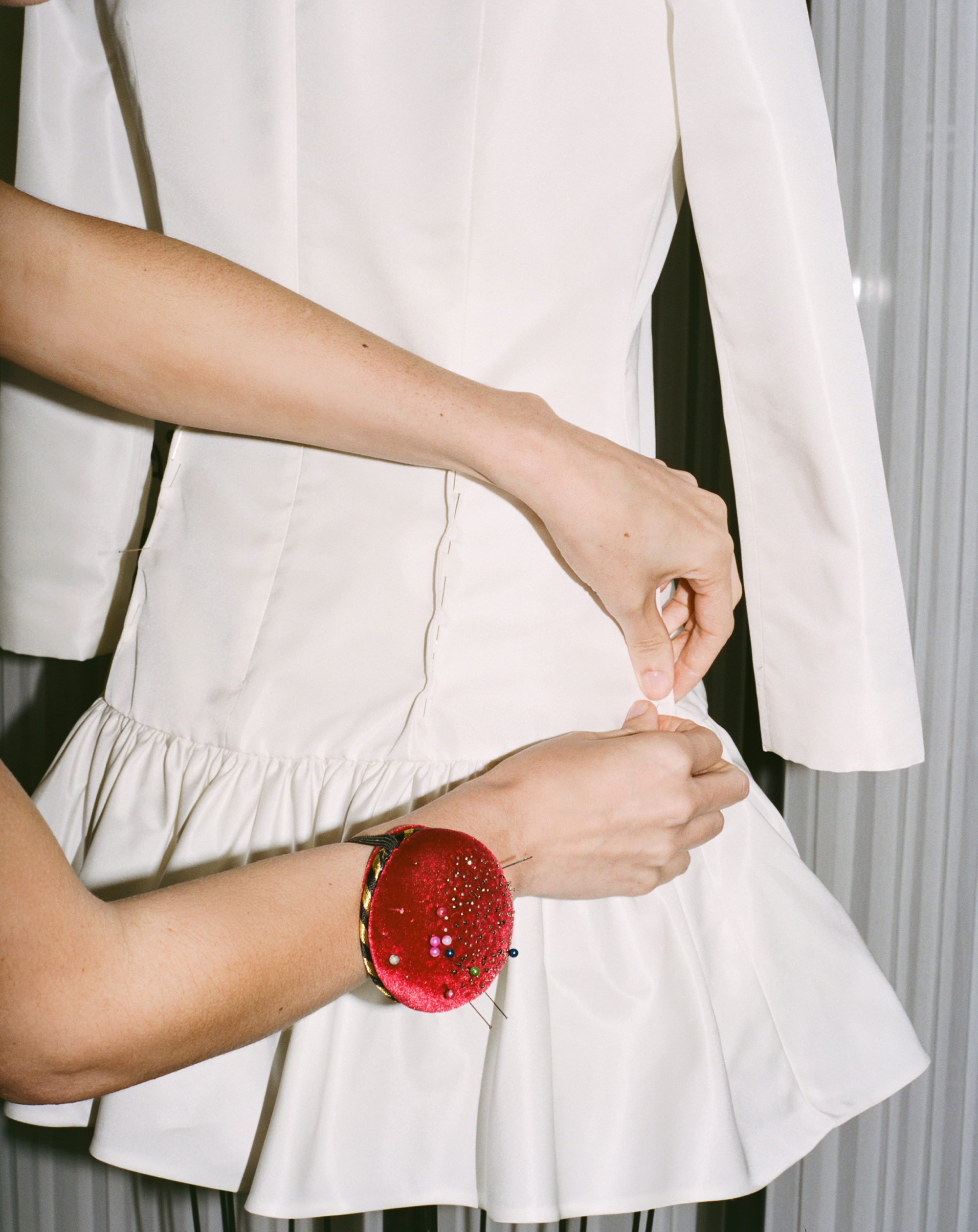 Tailor pinning Paige Lorenze's custom Wimbledon dress.