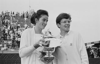 British tennis player Virginia Wade, holding the trophy, alongside American tennis player Billie Jean King, during the US Open presentation ceremony