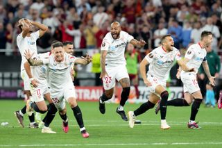 Sevilla's players celebrate victory on penalties against Roma in the 2023 Europa League final.