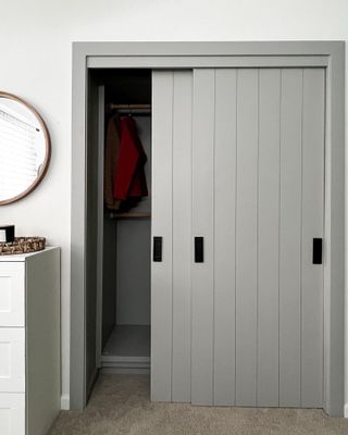 An IKEA PAX wardrobe painted in a soft grey color with shiplap effect doors
