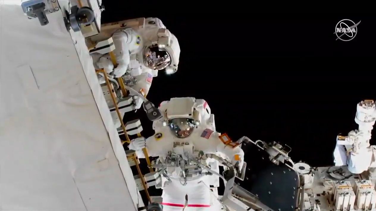 NASA astronauts Anne McClain holds one of the three adapter plates that was installed during today's spacewalk.