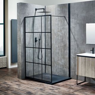 bathroom with grey wall shower cabin and wooden floor
