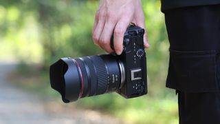 Canon RF 20-50mm f/4L IS USM PZ lens mounted to a Canon EOS R6 V, being held outdoors
