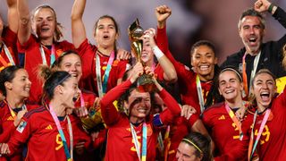 The Spanish Women's Football team celebrates with coach Jorge Vilda after their 1-0 victory over England