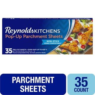 A blue cardboard box of Reynolds parchment paper sheets