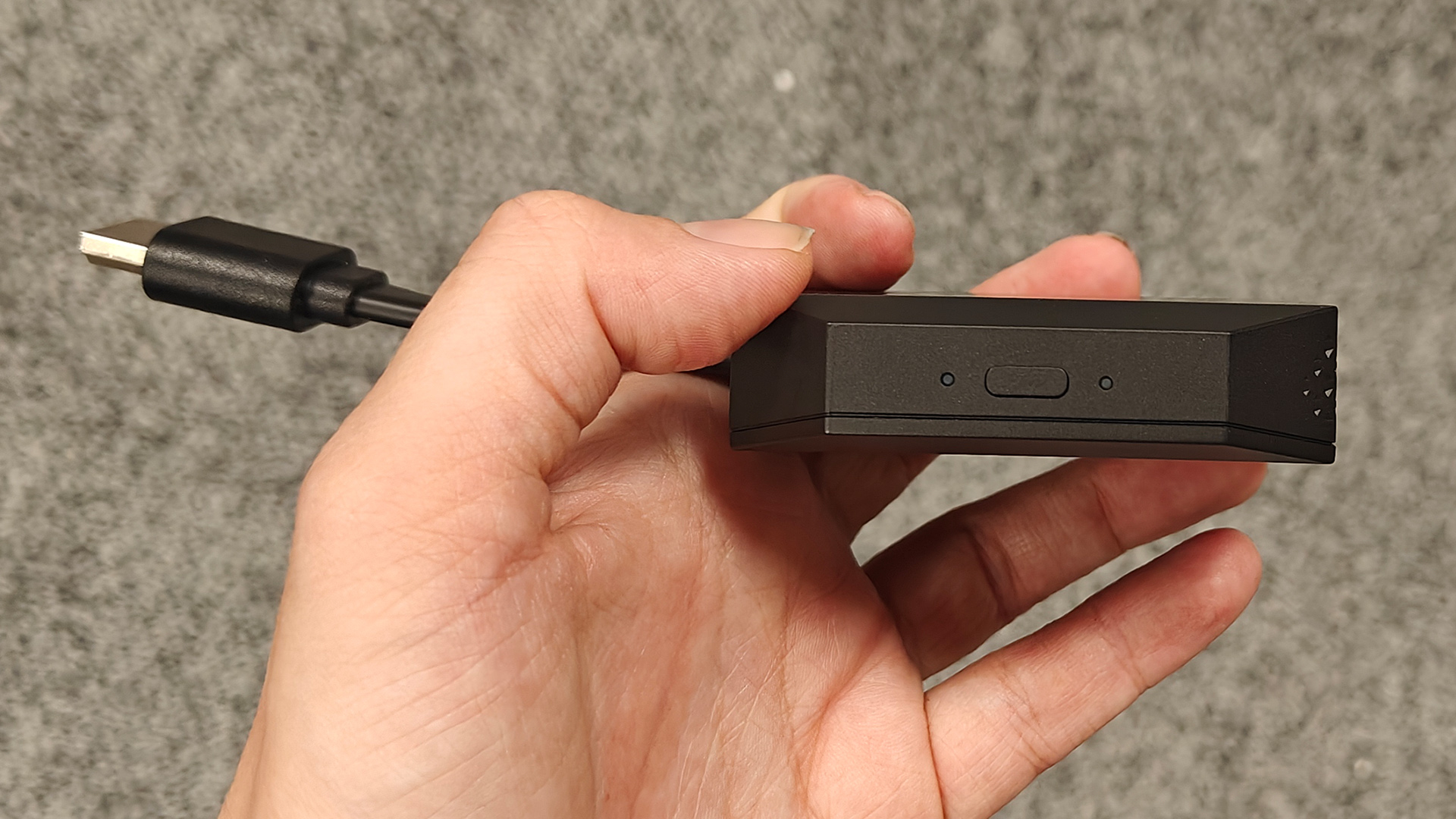 Valerion Thunderbeat 4.1.2 surround sound system wireless dongle held in hand