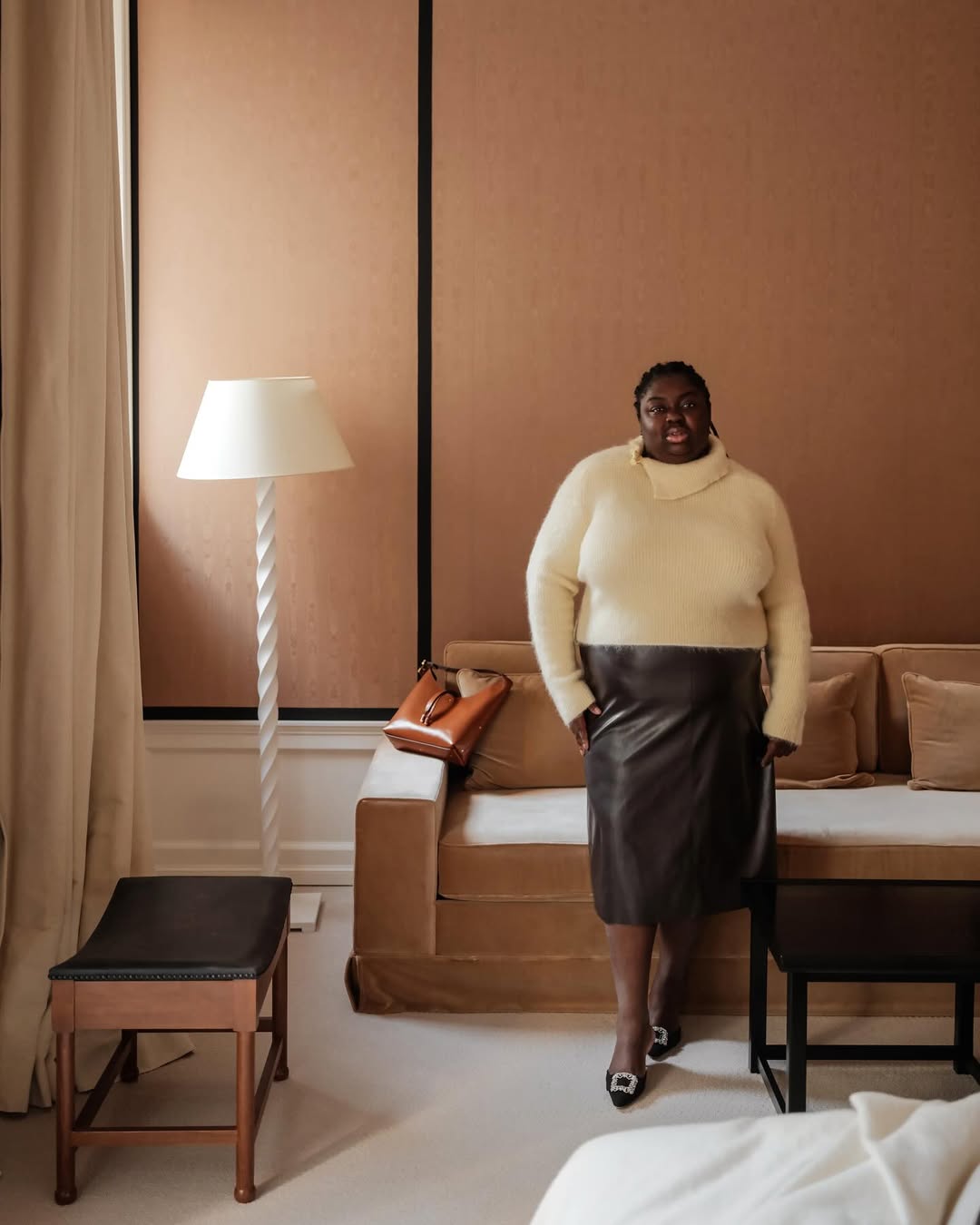 @abimarvel wears timeless winter outfit - yellow jumper, brown leather skirt