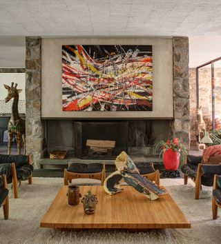 Pieces such as Mark Grotjahn's Untitled (Capri 53.16) painting, Gaetano Pesce's Large Red Pebble Vase and pieces by Jim McDowell and Lynda Benglis (on the tables) can be found in the house's living room