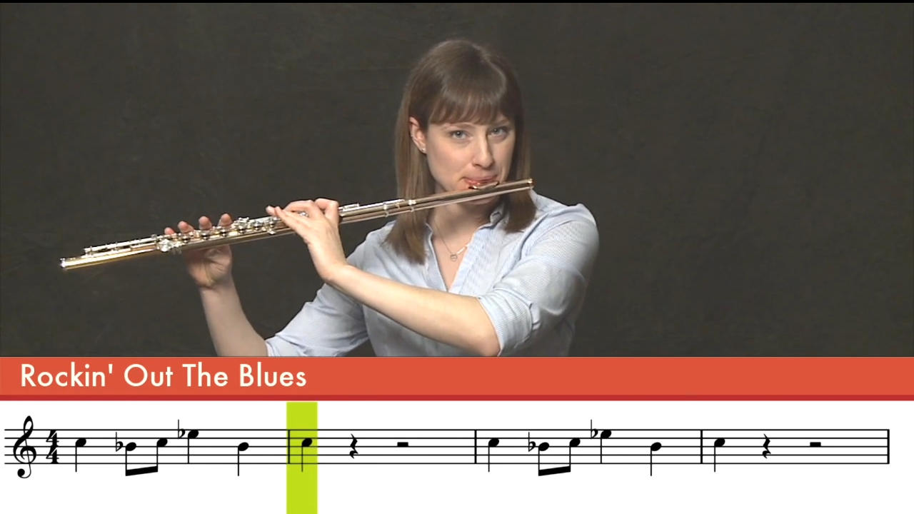 Woman playing flute, with musical score below "Rockin Out the Blues"