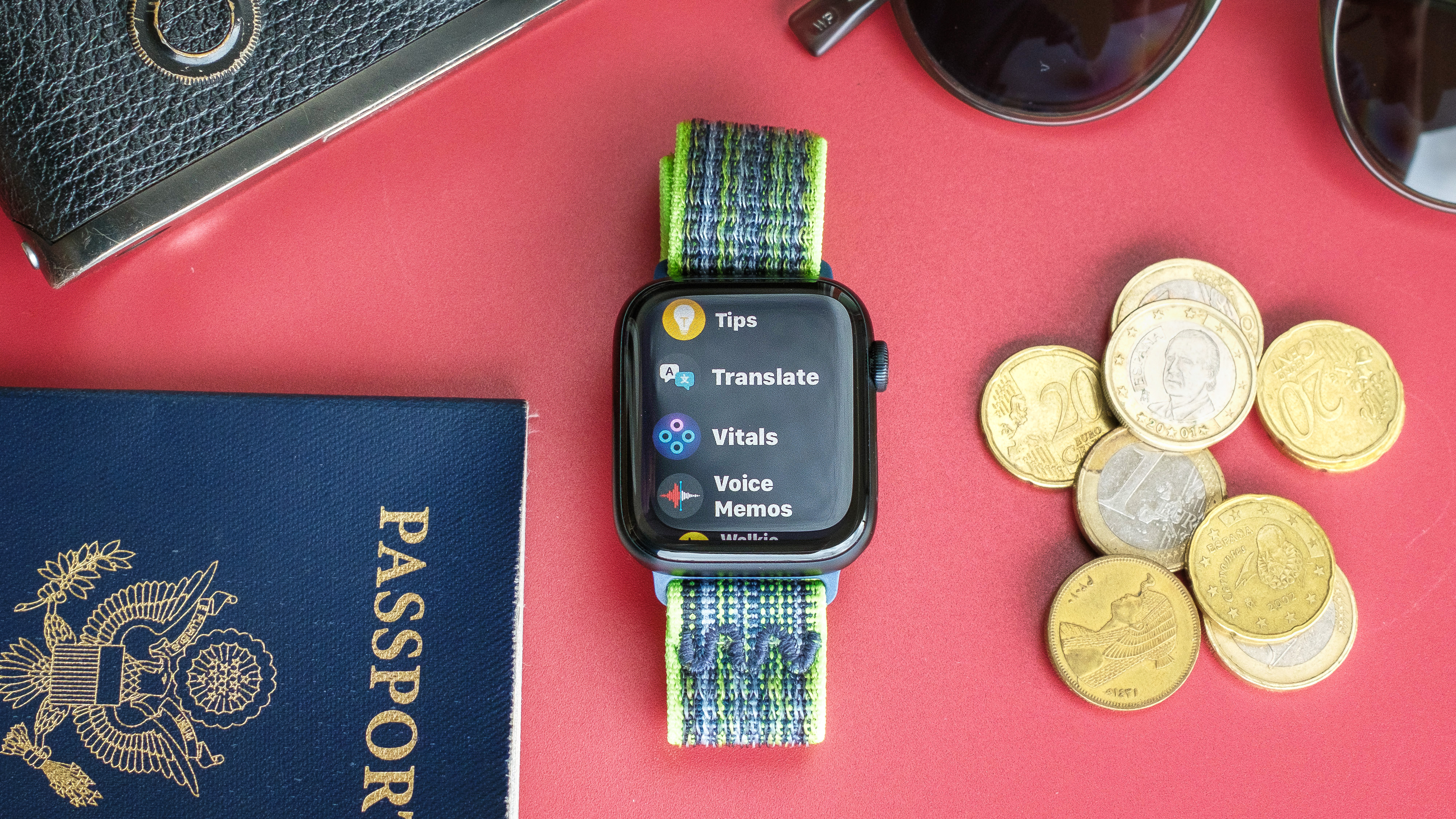 Close-up of an Apple Watch SE 2022 against a red background with the new Translate app on the screen