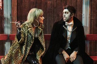 Count Abdulla stars Arian Nik and Jaime Winstone sitting on a bench in vampire costumes. 