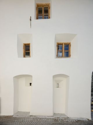 Exterior of Muzeum Susch with white walls and wooden window frames