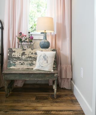 pink curtains with rustic chair in front