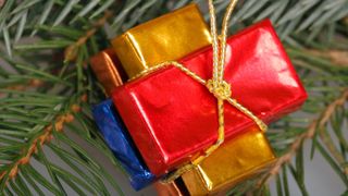 Christmas decorations, chocolate bars wrapped in colourful foil hung on a Christmas tree