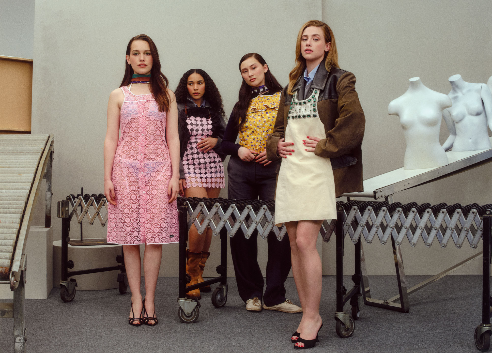 Forbidden Fruits actors for the Who What Wear 2026 Spring Issue posing all together in front of cream colored wall wearing various dresses, jackets, and bottoms