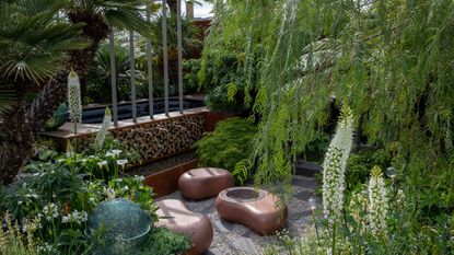 Wooden fence with wooden bench and greenery