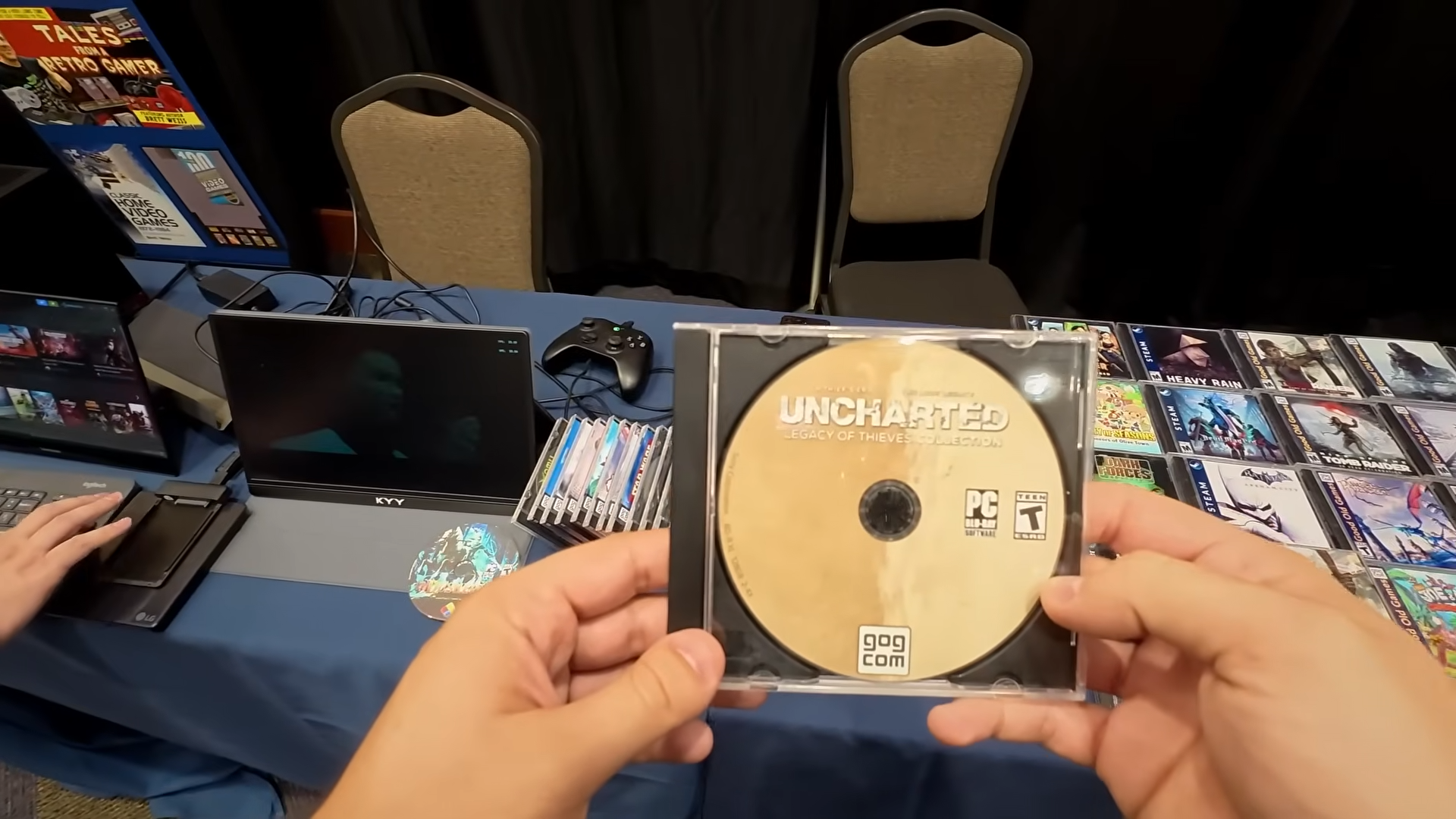 Hand holding custom Uncharted Legacy of Thieves collection disc for PC.