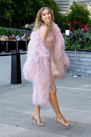 Suki Waterhouse wearing a sheer pink sequin dress with a matching shaggy coat for Michael Kors Spring/Summer 2025 runway show New York Fashion Week September 2024