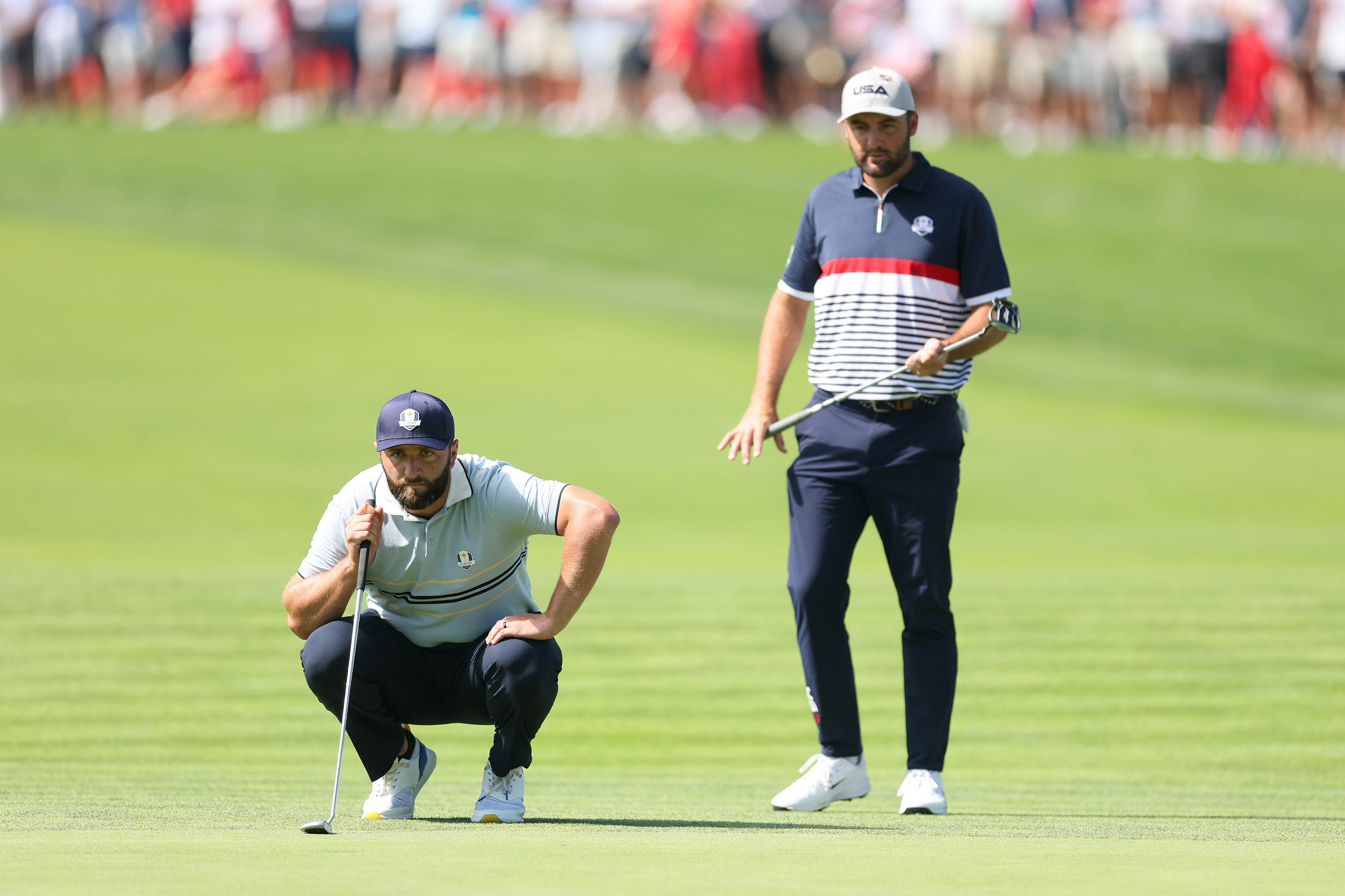 Jon Rahm and Scottie Scheffler line up putts
