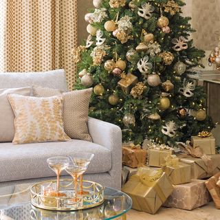 living room with christmas tree and golden decoration and face mask
