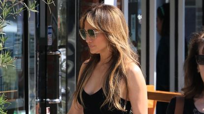 Jennifer Lopez walks in Los Angeles on August 5 wearing a black tank top and linen pants by St Agni, Meghan Markle&#039;s favorite brand