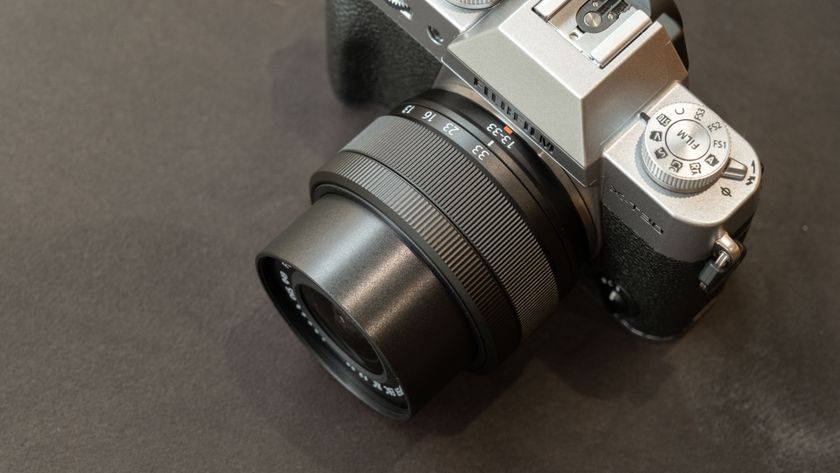 Close-up of the 13-33mm lens on a Fujifilm X-T30 III camera on a dark surface